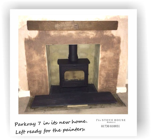 Fireplace opened up with solid oak beam and slate hearth.
