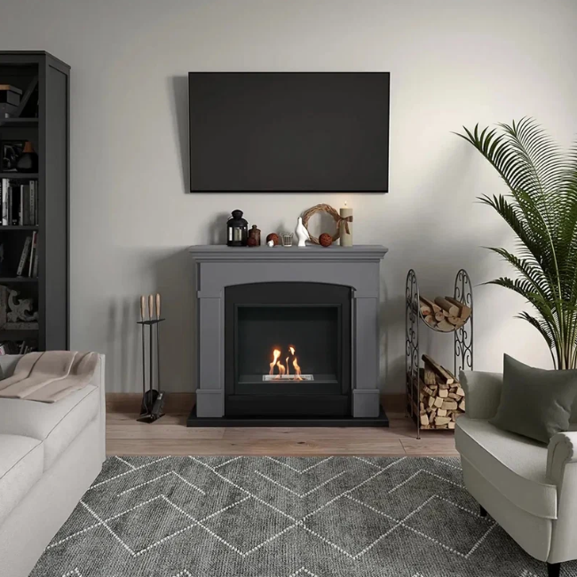 Helmi Bioethanol Fireplace Suite - Grey. Crafted from MDF with a classic grey finish, the Helmi fireplace is equipped with a bioethanol burner with a capacity of 2 litres, providing up to 5-6 hours of burn time and a heat output of up to 3 kW, at The Stove House Ltd. West Sussex.