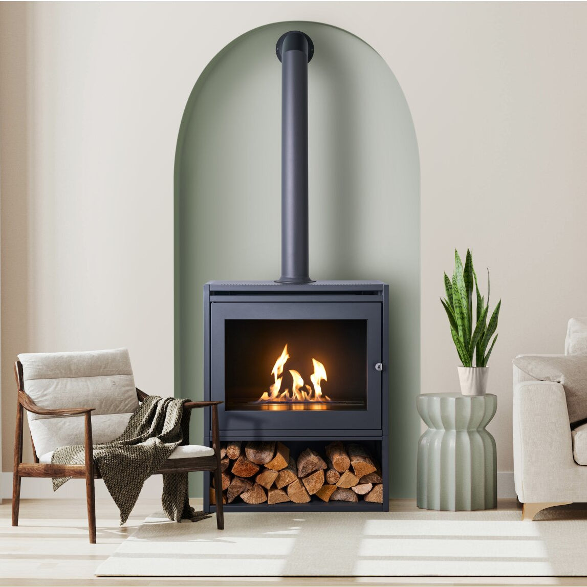 Image of an S6 on a log store with flue piope; A tall grey tube made of metal that sits ontop of a grey box like structure made of steel that has a metal chamber inside that houses BIOETHANOL fuel and you ignite and it produces heat. A 100% eco friendly renewable energy resource that's been turned into liquid. This is put into the metal chamber inside the fire box and lite to produce real flames and real heat and no chimney is required. 