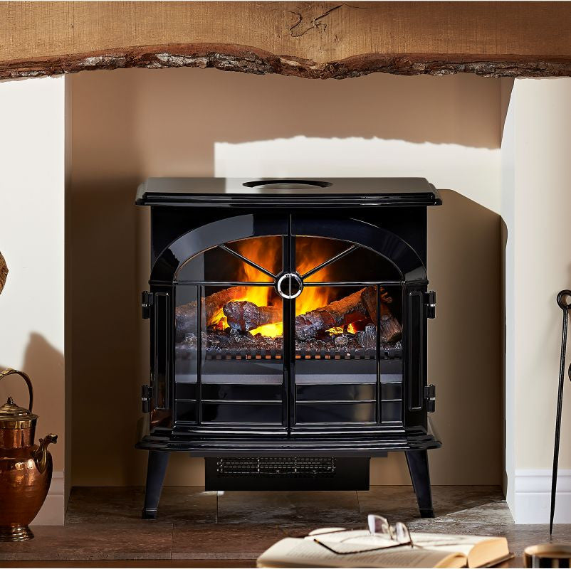 Dimplex Burgate Optimyst Electric Stove.  Integrated electric heater which provides up to 2kW of heat. This electric fire comes in a classic glass black finish with an LED lighting effect, remote control, and thermostat at The Stove House Ltd. West Sussex
